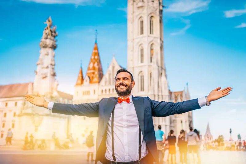 Happy man at Matthias Church near Fisherman's Bastion in Budapest