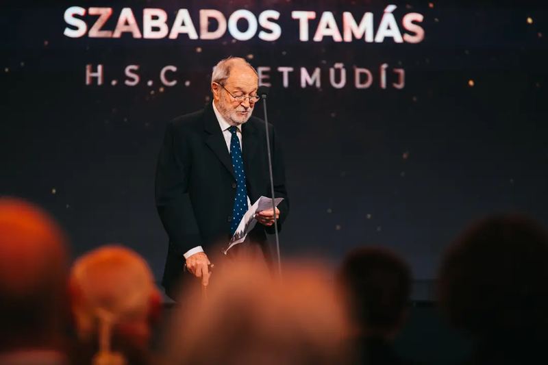 A person giving a speech at a business event in Budapest