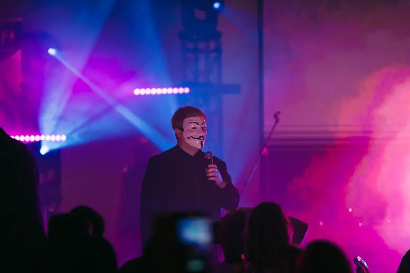Anonymous person, giving a speech at a charity party in Budapest