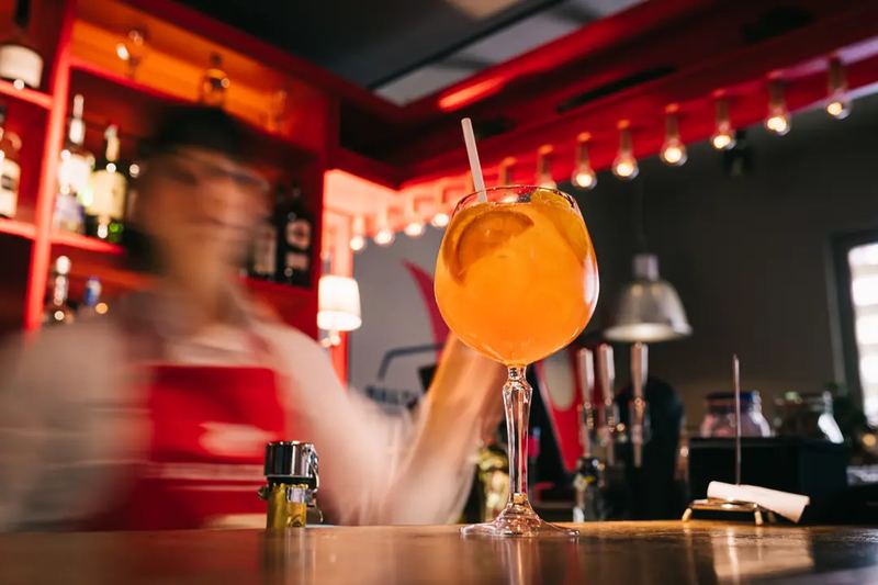 A bartender lady making a cocktail in a motion blur situation. Hotel Baltazar Budapest