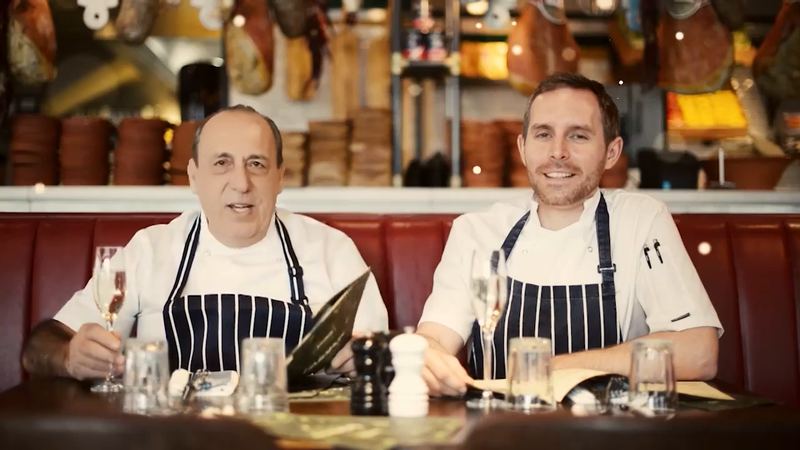 Two chefs at a restaurant table, from our portfolio reel